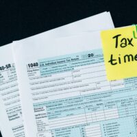 U.S. tax documents with a 'Tax time!' reminder, highlighting the importance of filing deadlines.